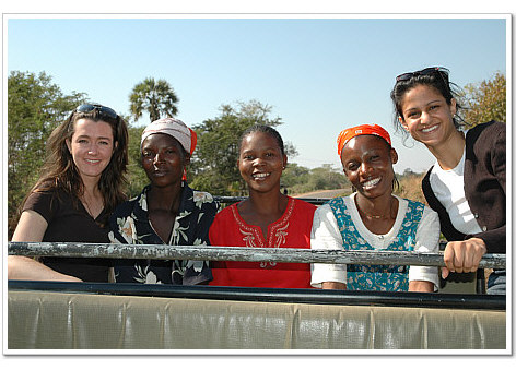 Two participants and Zambian ladies enjoy a drive in Mfuwe.